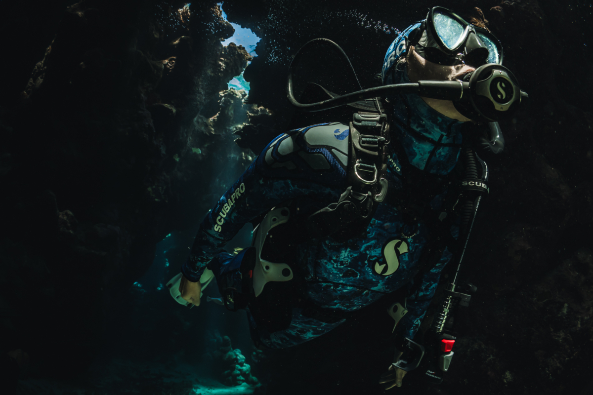 A scuba diver swims through a cave in Marsa Alam Egypt