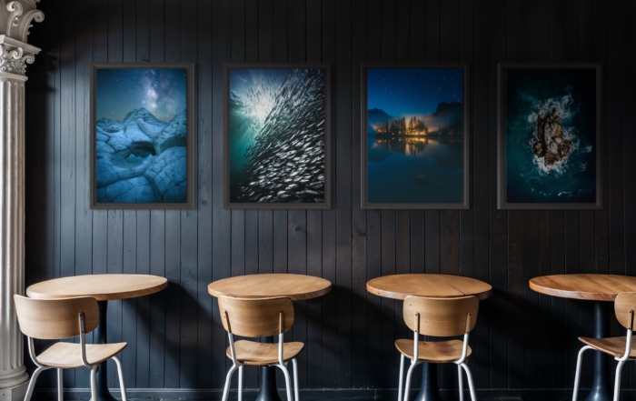 Limited edition photography prints by Jay Clue hanging on a restaurant wall. Featuring an image of the Milky Way night sky and underwater images.